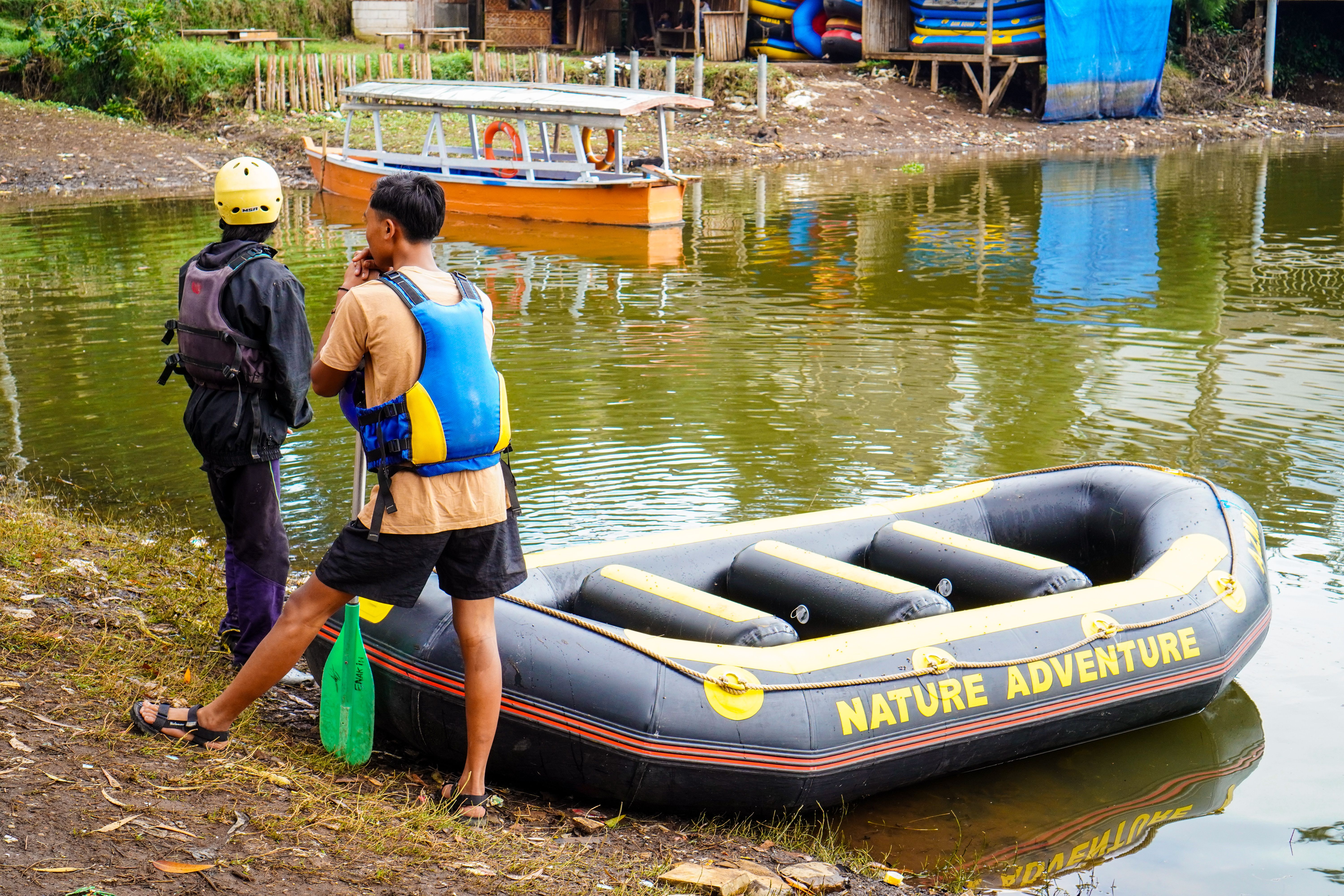 Two people prepare for a river rafting adventure in West Java, Indonesia.