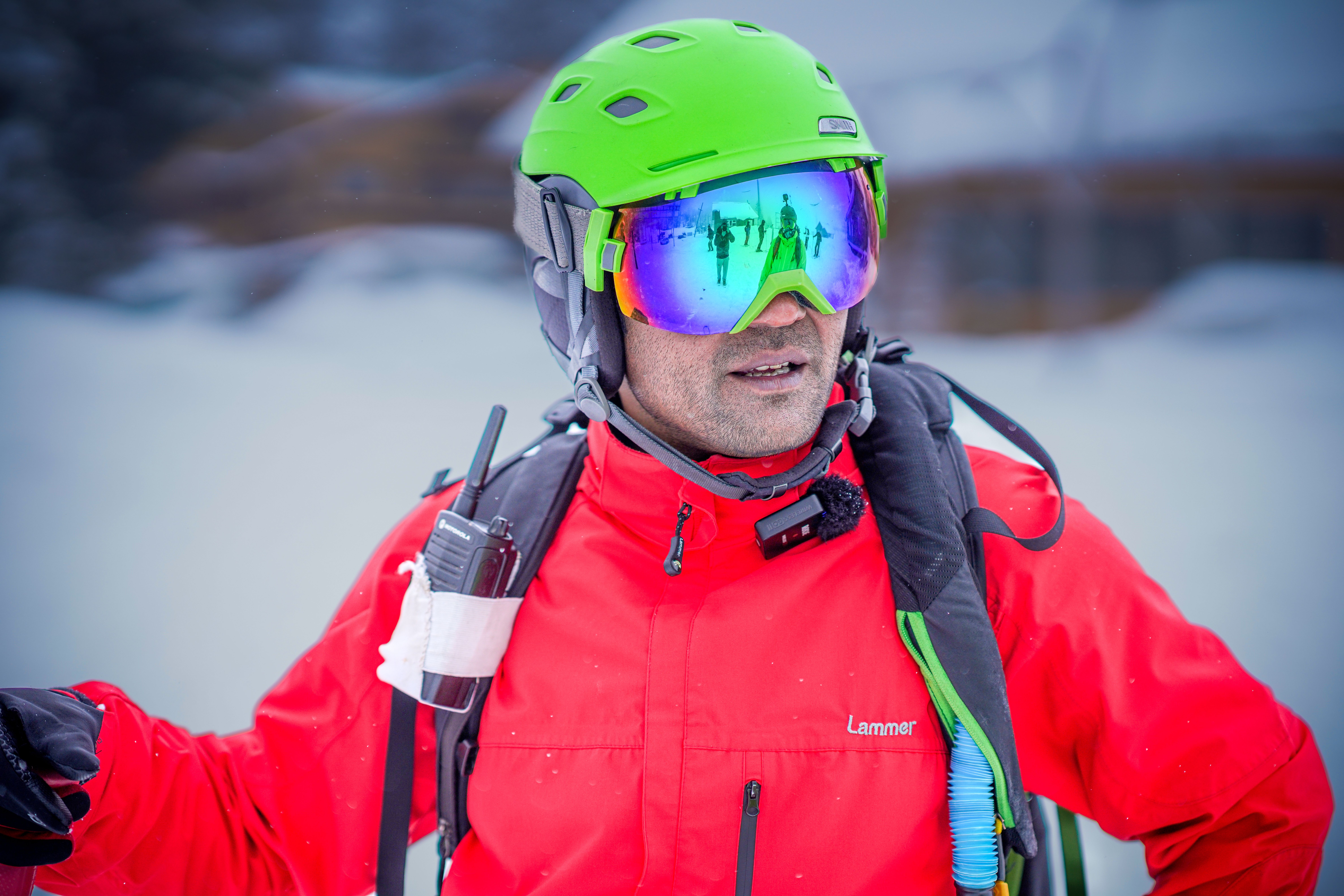 Adult skier with colorful goggles and safety gear ready for a winter adventure.