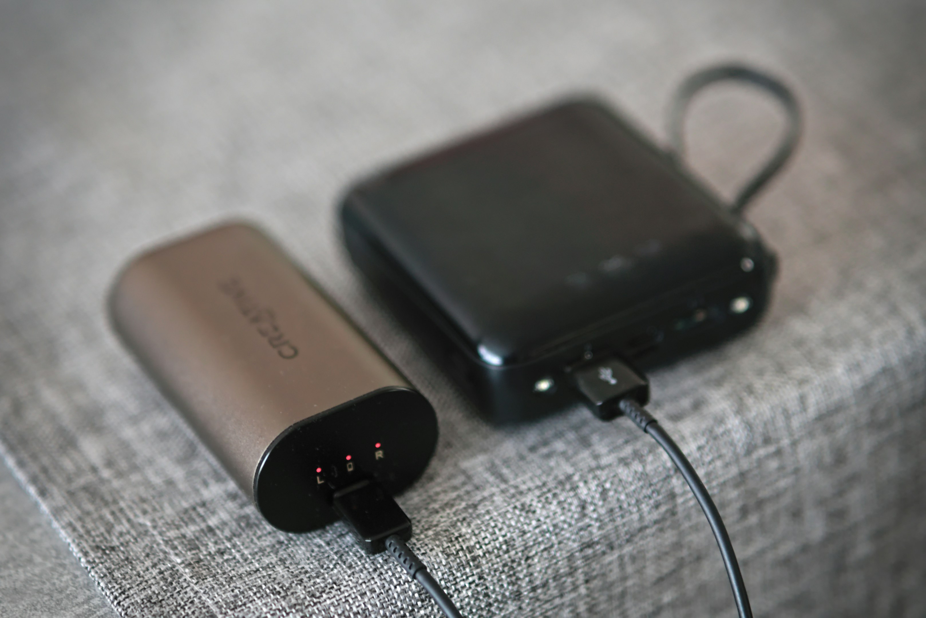 A couple of electronic devices sitting on top of a bed