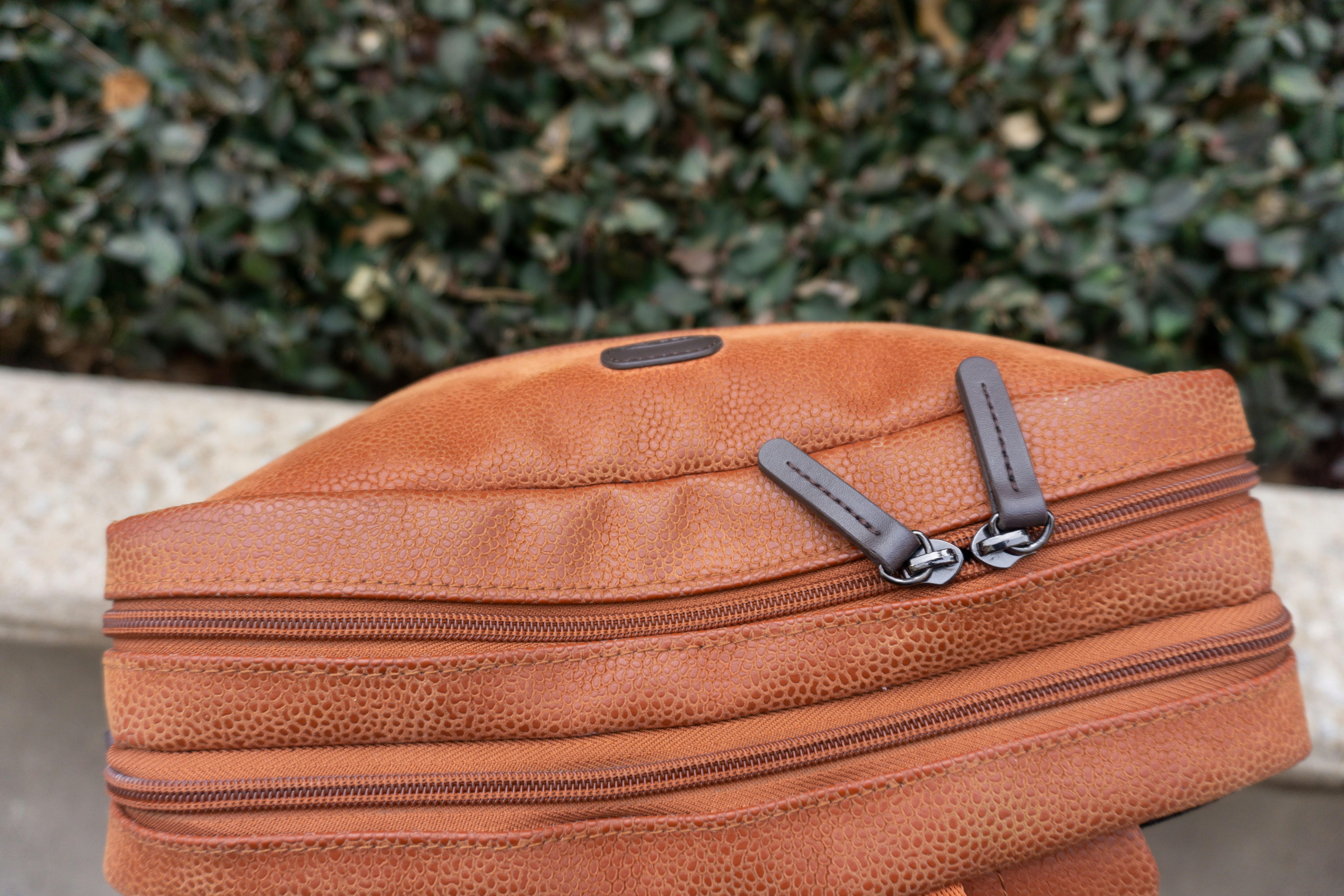 a brown hat with two zippers on it